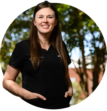 Caitlin Kickham poses for a photo in black scrubs