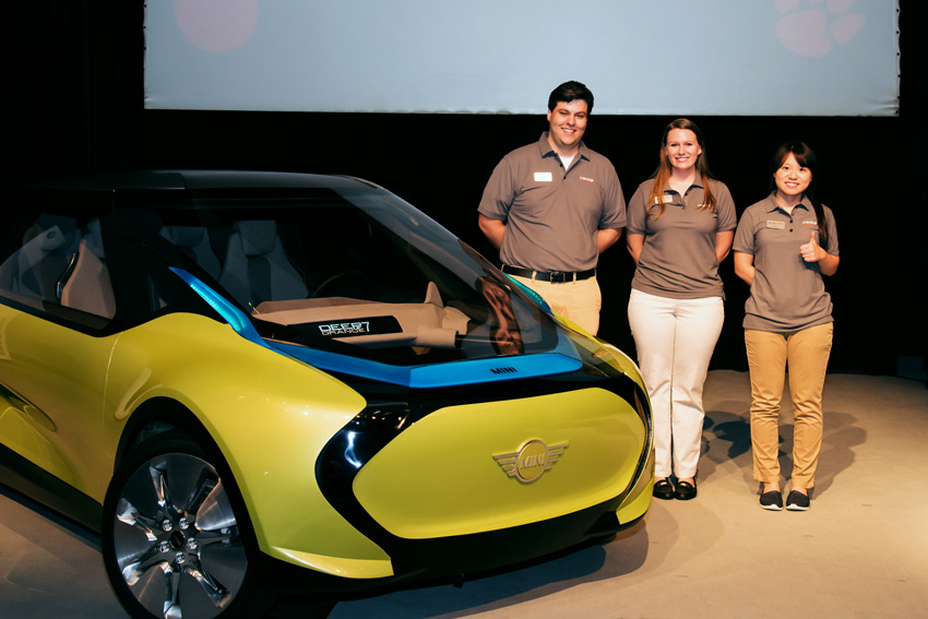 A team of grad students poses with a protoype vehicle