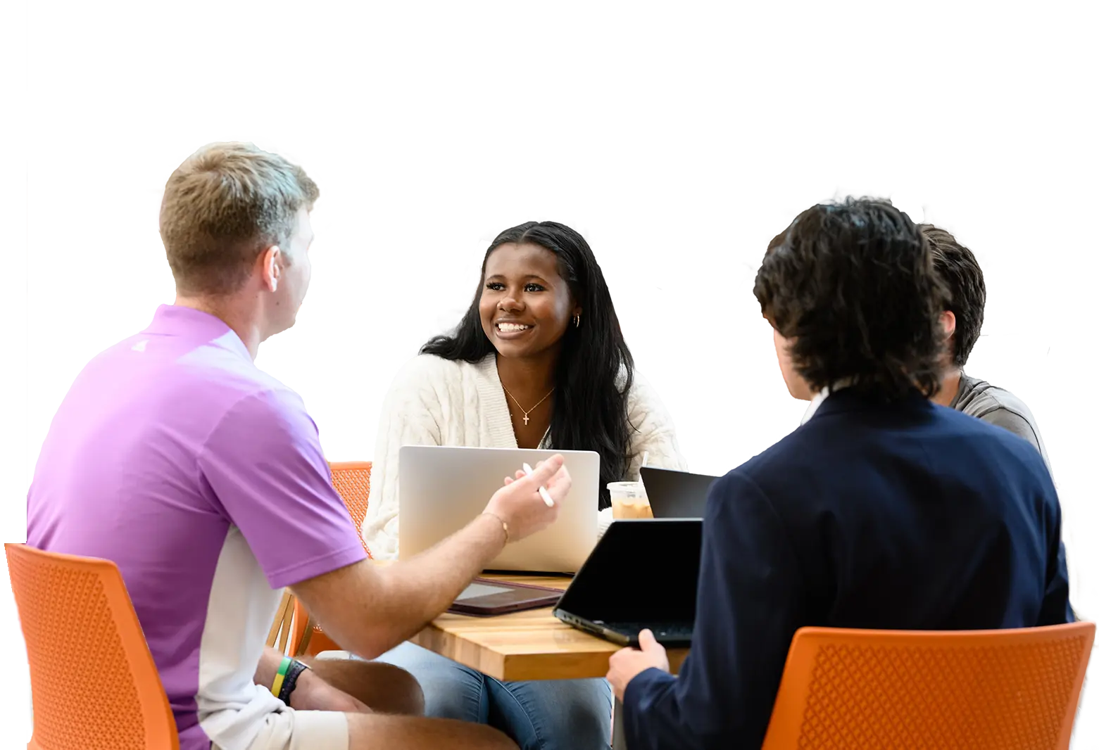 a group of students sits around a table in conversation