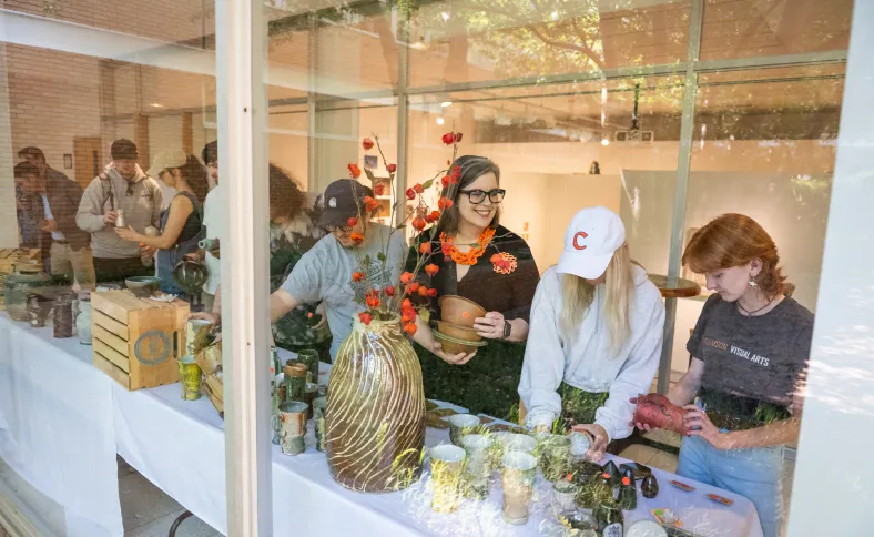 Students peruse pottery at the bi-annual ceramics sale in Lee Hall. 