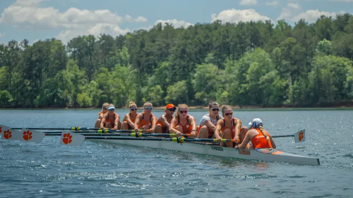 A female crew team rows across Lake Hartwell. 