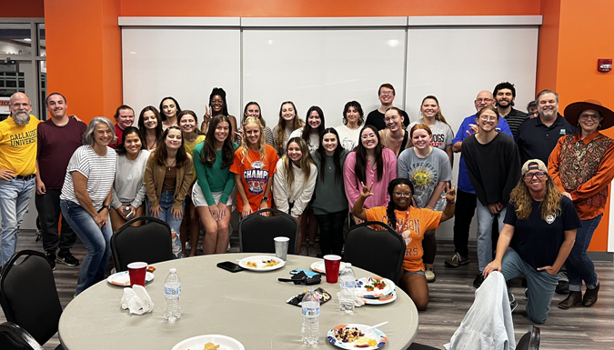 students, faculty and staff posing arm in arm for a group photo of Clemson's ASL club