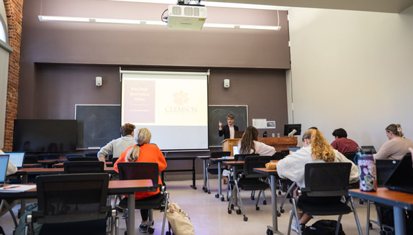 instructor teaching in front of a small group of students 