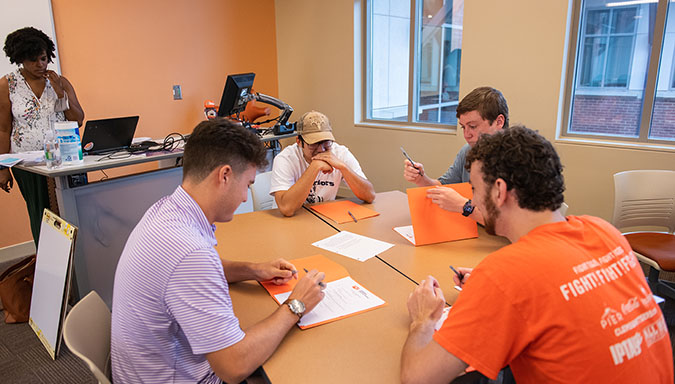 Students engaged in a collaborative group activity during a tutor training session.