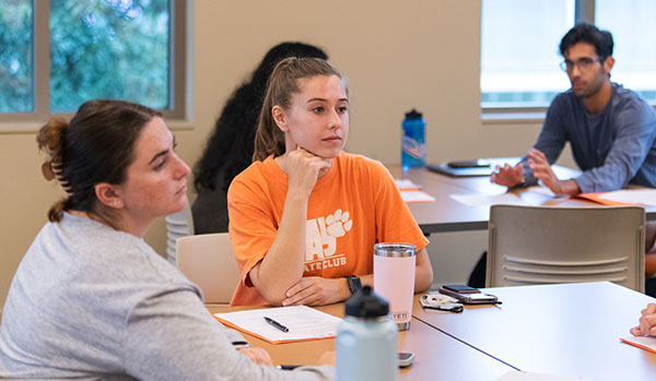 Students engaged in a discussion during tutor training, showcasing collaboration and focus.