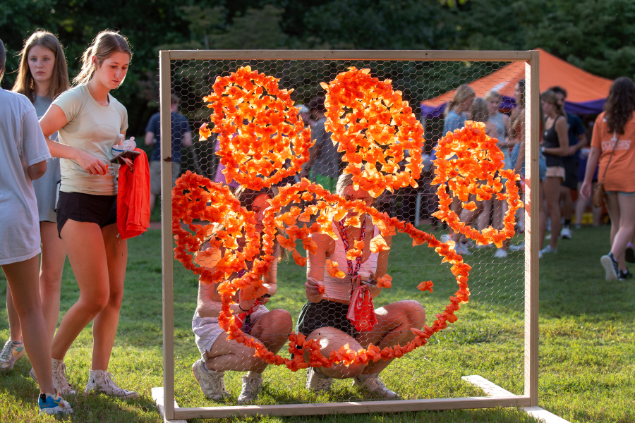 Students create a Tiger Paw with orange tissue paper during the Homecoming float build. 