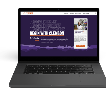 laptop computer showing a webpage with 'Begin With Clemson' in large white block letters on a dark purple background