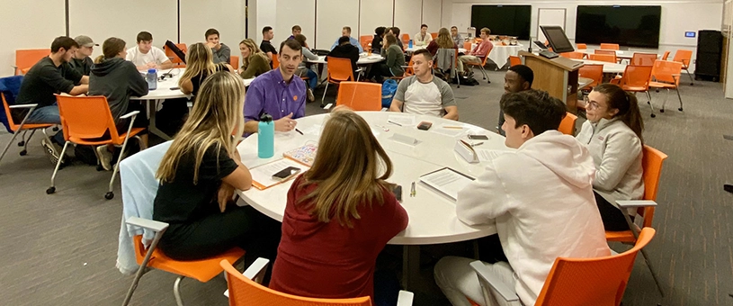 students at tables in large room