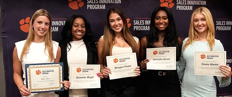 Four female students receiving awards.