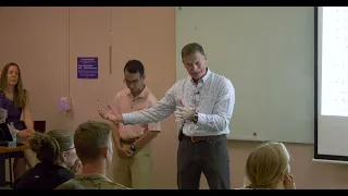 Man and student presenting to class