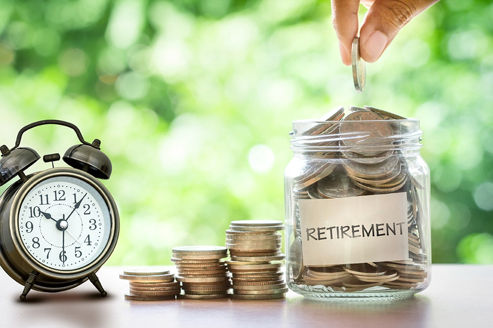 Stock image depicting retirement funds in a jar and a clock ticking.