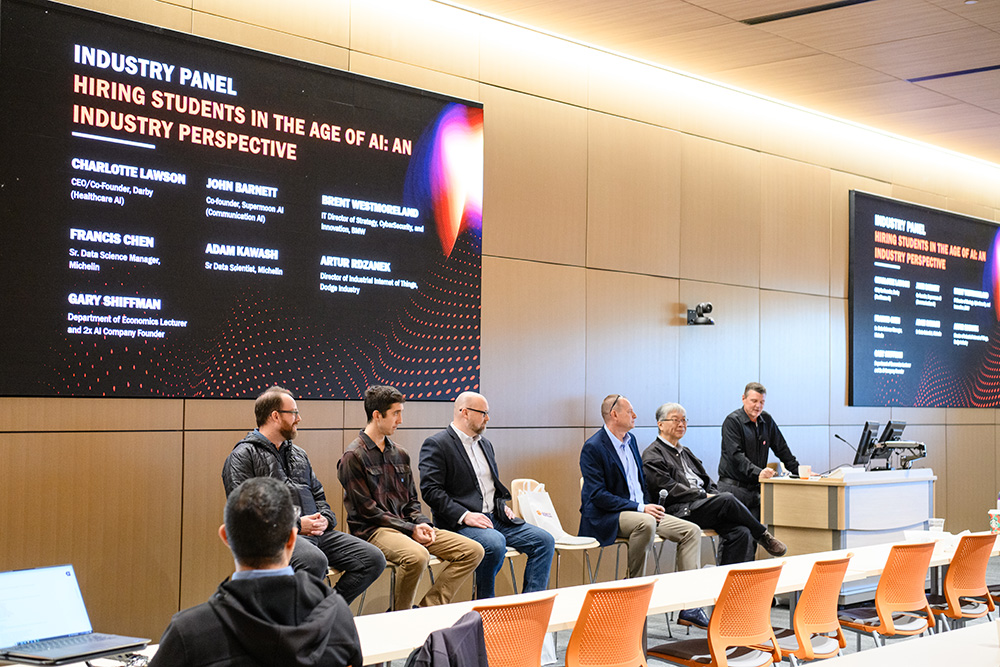 A professional panel discussion featuring industry experts discussing the impact of AI on hiring students.