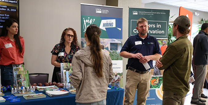 students talking to employers at career fair