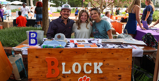 students at a stand outside