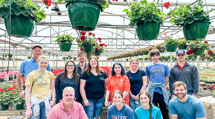 Students standing in a greenhouse