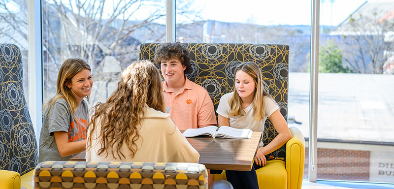 a group on students talking at a table