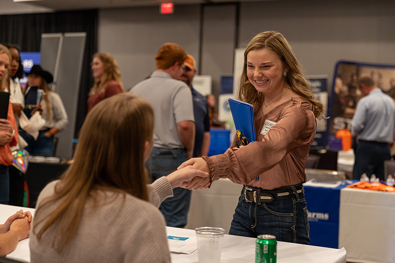 student meeting with employer at career fair