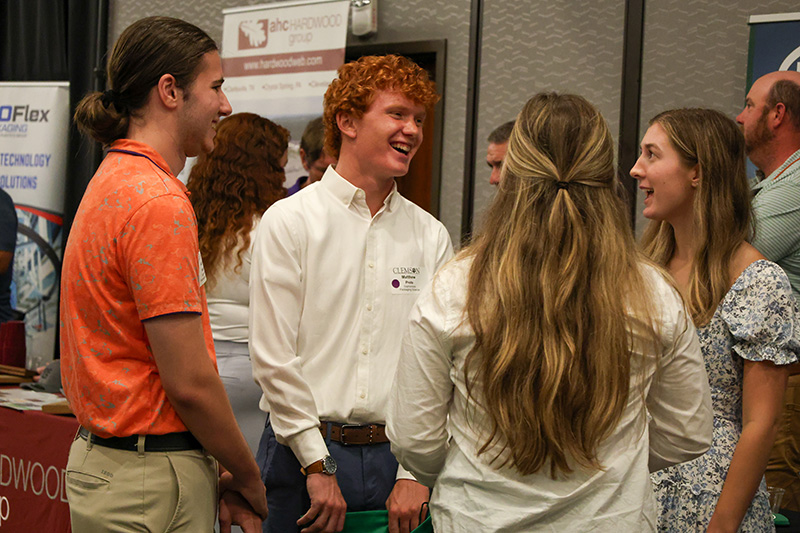 a bunch of students talking at the career fair