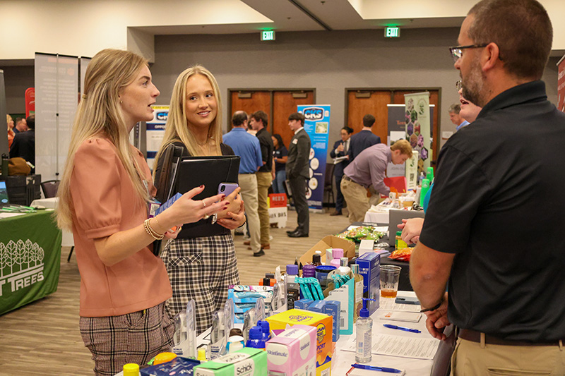 students speaking to employers at career fair