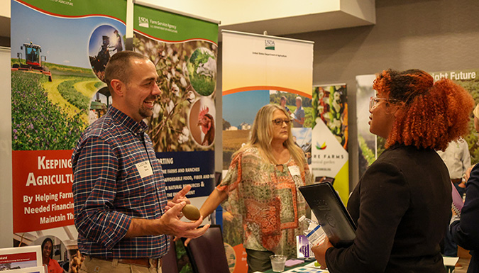 student speaking to employer in career fair