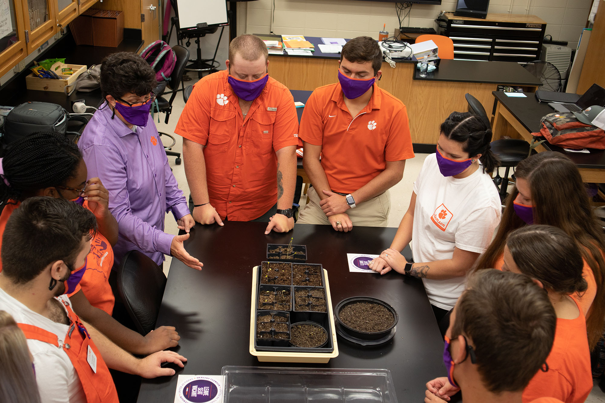 Class photo of students around lab table