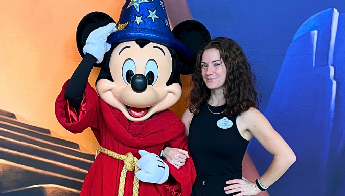 Madi Coli poses with Mickey Mouse at Disney Magic Kingdom