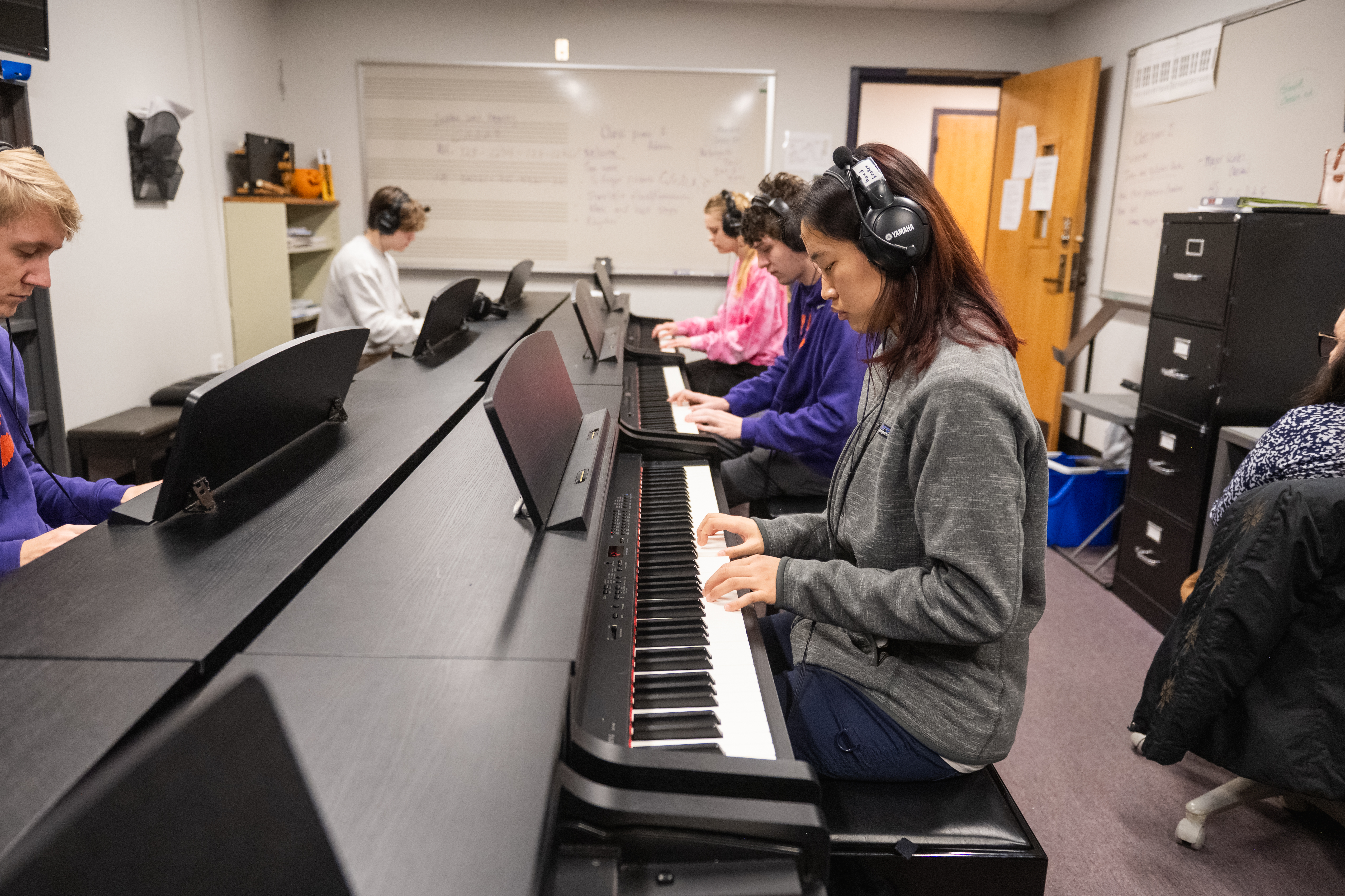 Students playing keyboards in the keyboard studio