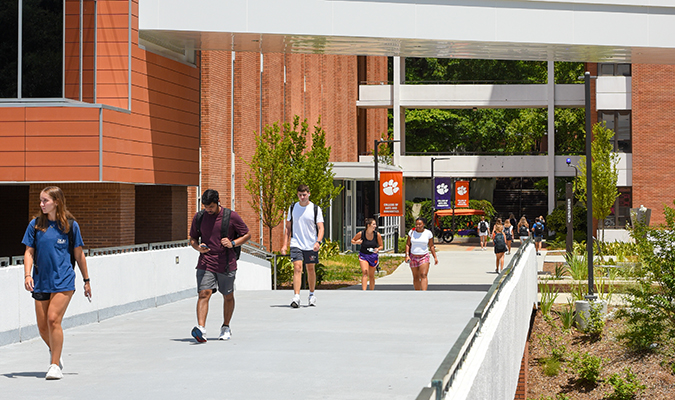 students walk on Clemson's campus near Daniel Hall