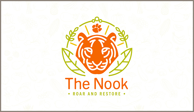 icon of orange tiger surrounded by green filigree with The Nook written in orange 