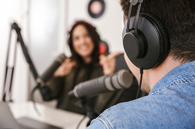 Two people podcasting