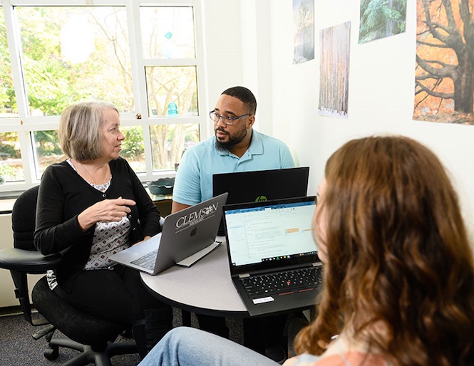 Three people having a meeting