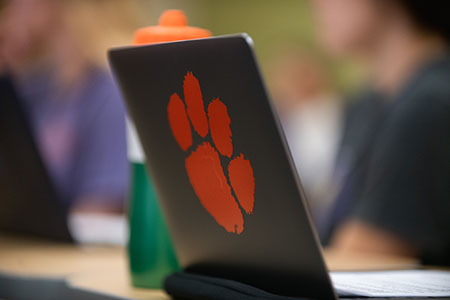 Laptop with a tiger paw sticker on the outside lid