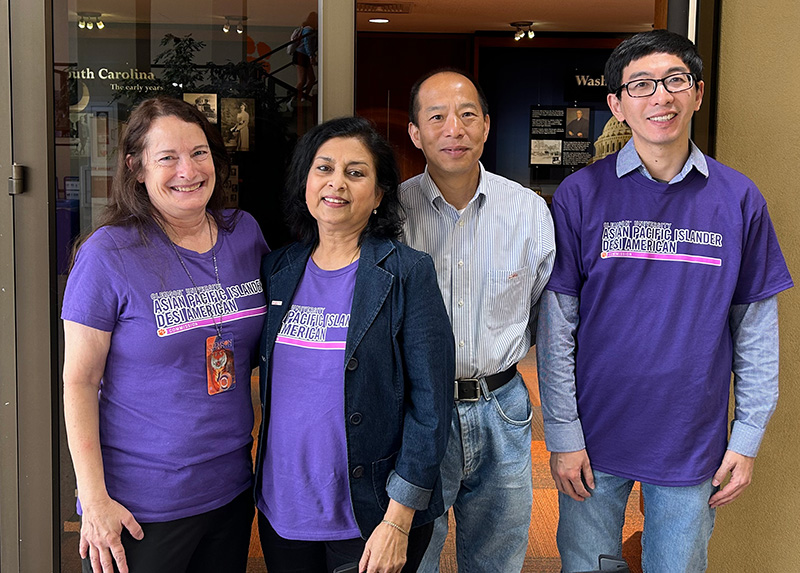 Commission members wear matching purple APIDA  t-shirts