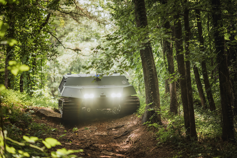 Tracked vehicle descending a slope in the woods