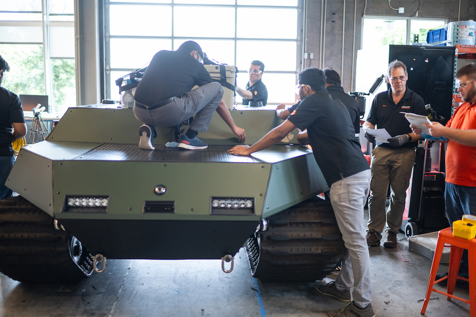 Students loading equipment onto the DO14 vehicle