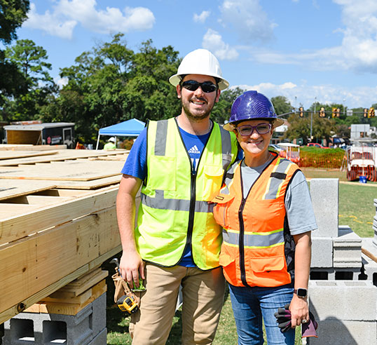 Zoraya Rockow and student on Bowman Field during house building project.