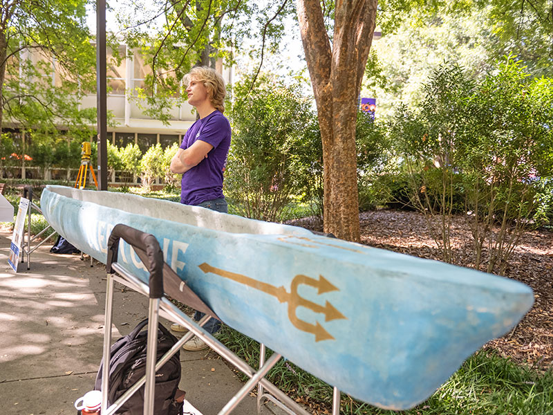 Student with canoe at fall showcase