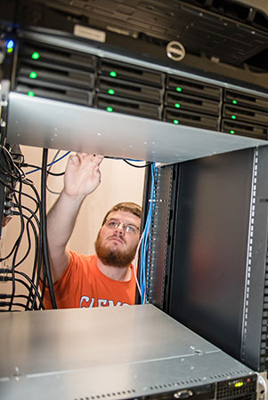 Student in server room, looking up