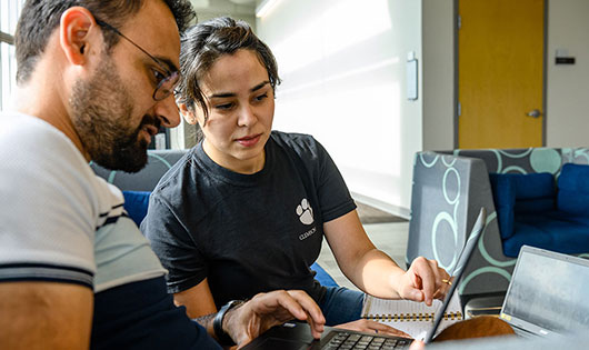 Two students on laptop in Charleston