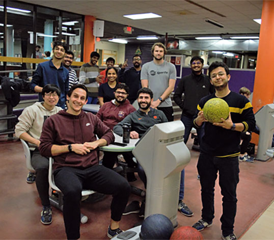 Graduate students gathered at bowling alley