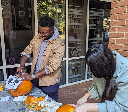 Halloween pumpkin carving outside of Fluor Daniel