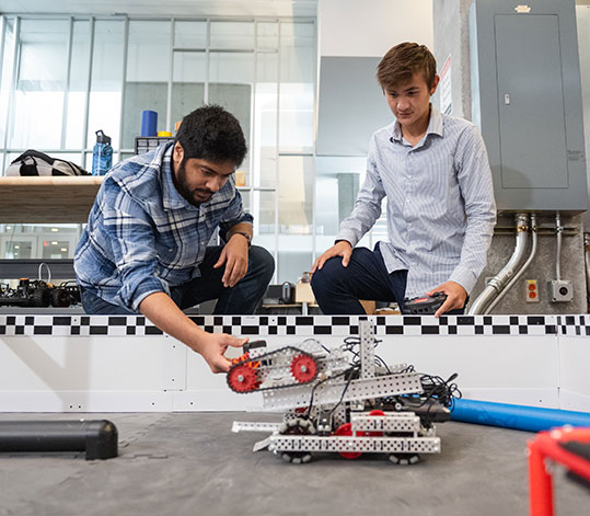 Student and faculty with remote vehicle