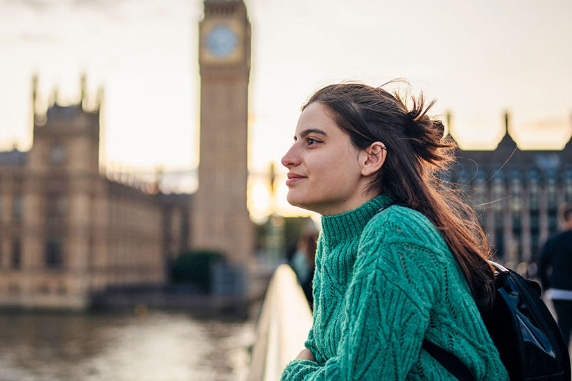 Student in London overlooking river