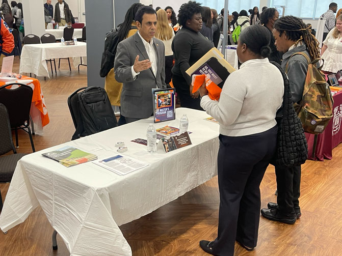 Students asking questions at banquet table