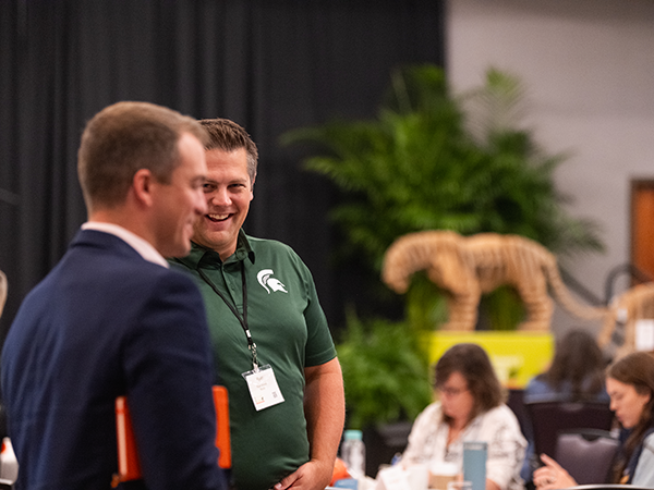 two men talking at the summit event