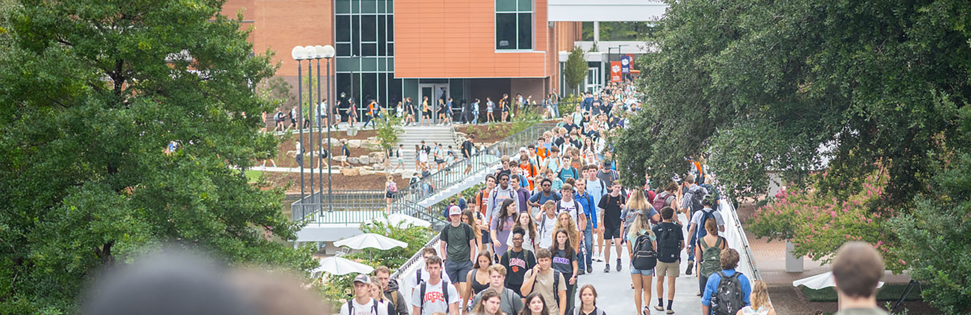 Students walking on the bridge in front of the library