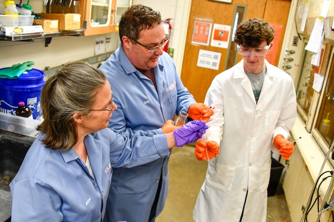 Julia Brumaghim, Modi Wetzler and Maclean Hutmacher discuss their progress in the laboratory.