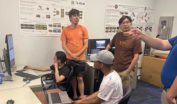 SPRI students talking with their mentors in a Clemson lab.