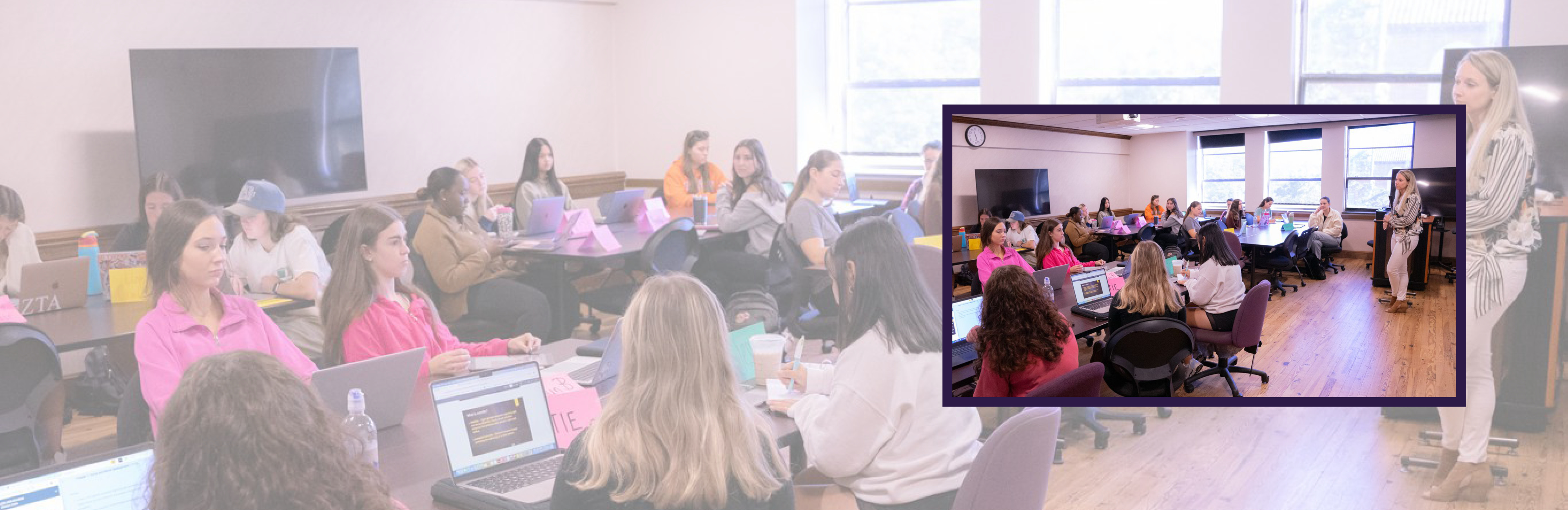 A classroom with undergraduates at tables, listening to the instructor in the front of the room.