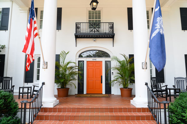 The exterior of the Clemson presidents home front door, flanked by the American and South Carolina flag.